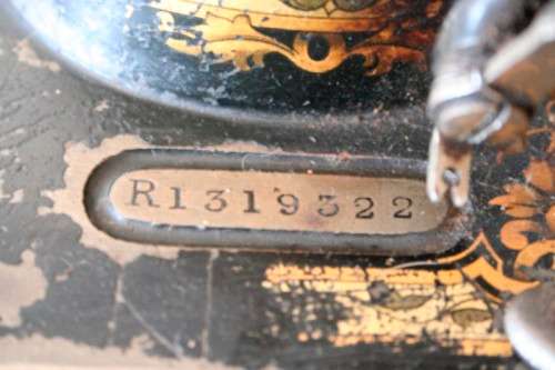 A remarkable antique (1903) Singer hand cranked sewing machine in its original casing.