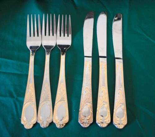 A 68-piece Edelstahl Rostfrei gold scroll trim flatware cutlery set in its original briefcase.