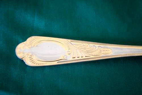A 68-piece Edelstahl Rostfrei gold scroll trim flatware cutlery set in its original briefcase.
