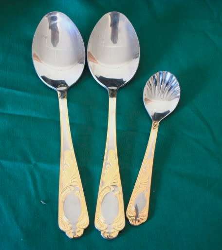 A 68-piece Edelstahl Rostfrei gold scroll trim flatware cutlery set in its original briefcase.