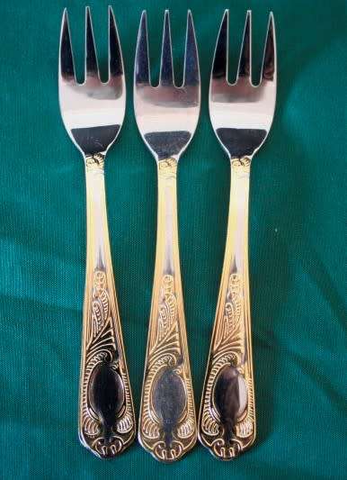 A 68-piece Edelstahl Rostfrei gold scroll trim flatware cutlery set in its original briefcase.