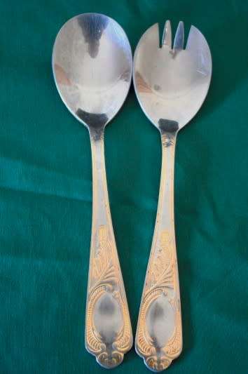 A 68-piece Edelstahl Rostfrei gold scroll trim flatware cutlery set in its original briefcase.