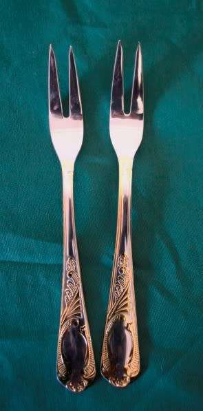 A 68-piece Edelstahl Rostfrei gold scroll trim flatware cutlery set in its original briefcase.