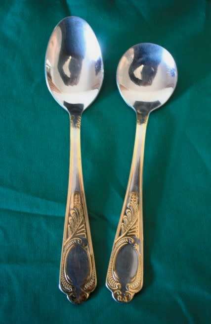 A 68-piece Edelstahl Rostfrei gold scroll trim flatware cutlery set in its original briefcase.