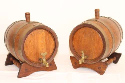 A fantastic and very well made miniature solid oak whiskey barrel on a stand w/ brass tap & stopper