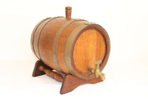 A fantastic and very well made miniature solid oak whiskey barrel on a stand w/ brass tap & stopper