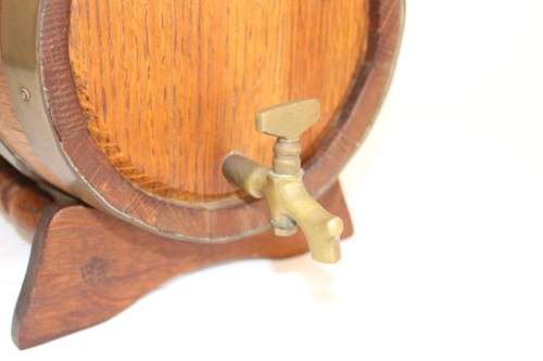 A fantastic and very well made miniature solid oak whiskey barrel on a stand w/ brass tap & stopper
