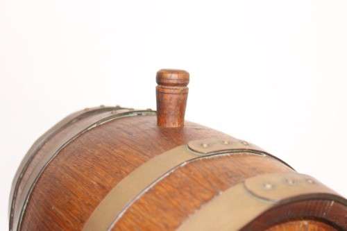 A fantastic and very well made miniature solid oak whiskey barrel on a stand w/ brass tap & stopper