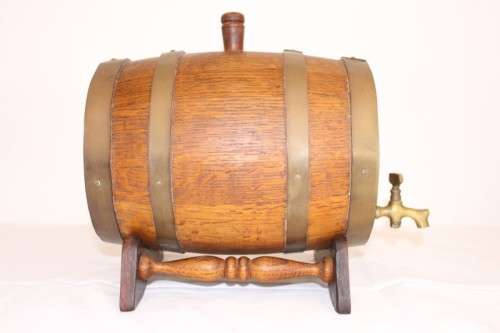 A fantastic and very well made miniature solid oak whiskey barrel on a stand w/ brass tap & stopper