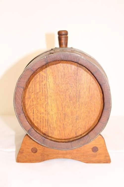 A fantastic and very well made miniature solid oak whiskey barrel on a stand w/ brass tap & stopper