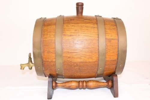 A fantastic and very well made miniature solid oak whiskey barrel on a stand w/ brass tap & stopper