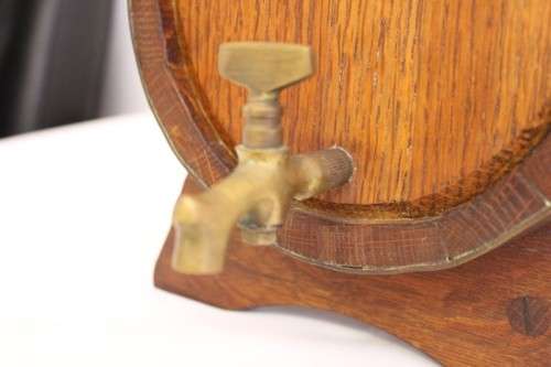 A fantastic and very well made miniature solid oak whiskey barrel on a stand w/ brass tap & stopper