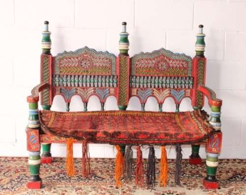 A rare antique brightly coloured wedding seat from the Swati Valley in Pakistan w/ a Persian cushion
