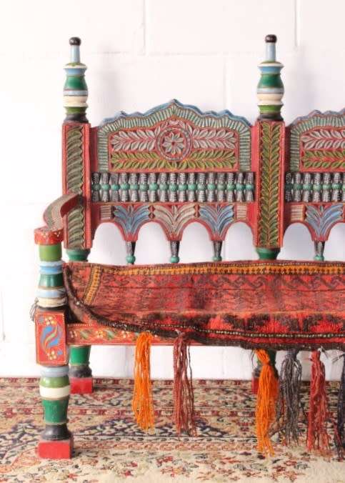 A rare antique brightly coloured wedding seat from the Swati Valley in Pakistan w/ a Persian cushion