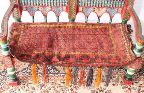 A rare antique brightly coloured wedding seat from the Swati Valley in Pakistan w/ a Persian cushion