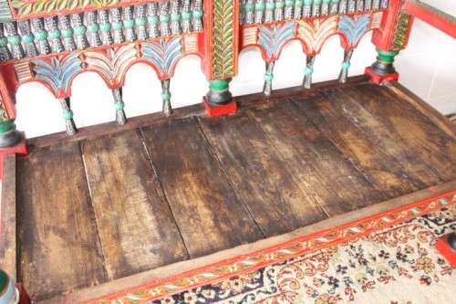 A rare antique brightly coloured wedding seat from the Swati Valley in Pakistan w/ a Persian cushion