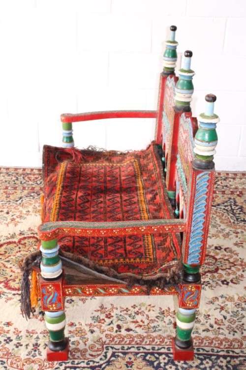 A rare antique brightly coloured wedding seat from the Swati Valley in Pakistan w/ a Persian cushion
