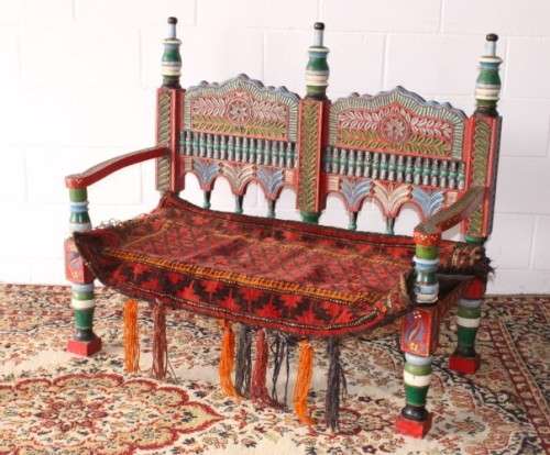 A rare antique brightly coloured wedding seat from the Swati Valley in Pakistan w/ a Persian cushion