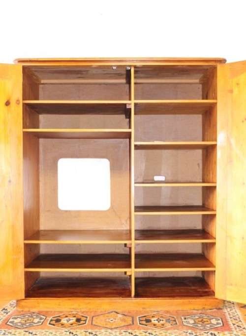 A solidly made double door SA pine storage cabinet with an array of shelves and storage space