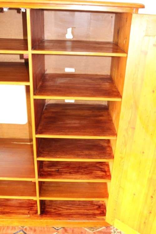 A solidly made double door SA pine storage cabinet with an array of shelves and storage space