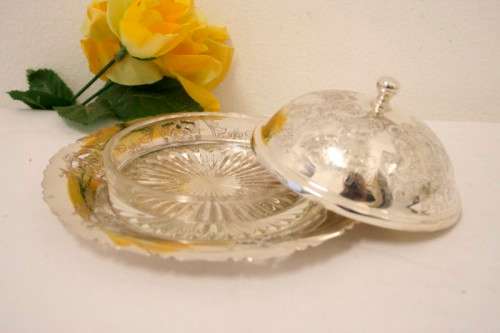 A gorgeous vintage silver plated lidded breakfast butter dish with an ornate lid and glass dish.