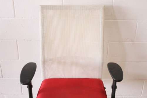 A modern styled red and white office chair with tilt, height and tension adjusters
