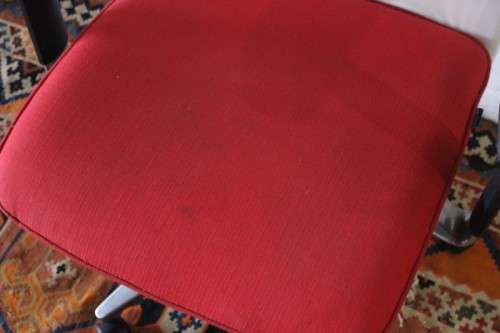 A modern styled red and white office chair with tilt, height and tension adjusters