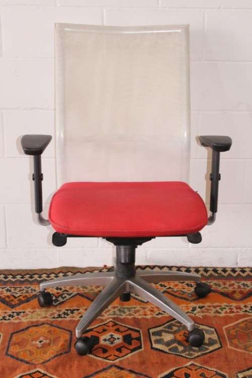 A modern styled red and white office chair with tilt, height and tension adjusters
