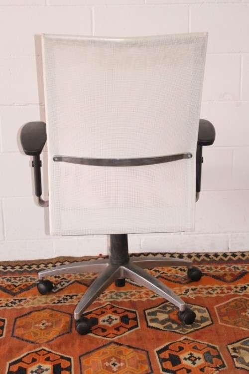 A modern styled red and white office chair with tilt, height and tension adjusters