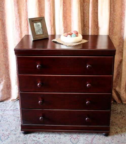 A beautiful modern four-drawer chest of drawers with ample packing space & round wood handles