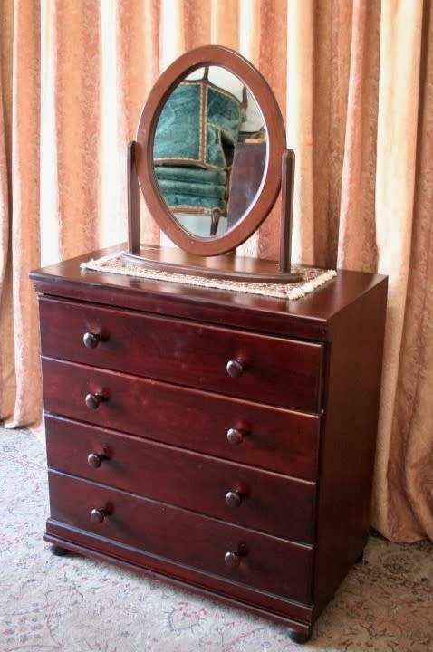 A beautiful modern four-drawer chest of drawers with ample packing space & round wood handles