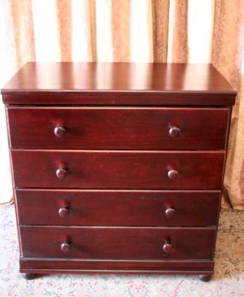 A beautiful modern four-drawer chest of drawers with ample packing space & round wood handles