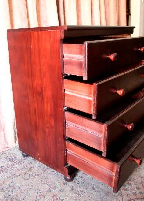 A beautiful modern four-drawer chest of drawers with ample packing space & round wood handles