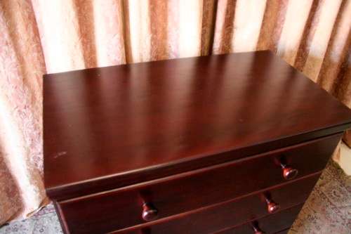 A beautiful modern four-drawer chest of drawers with ample packing space & round wood handles