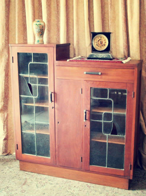 A fantastic solid Teak display cabinet w lead glass doors & large cupboards.
