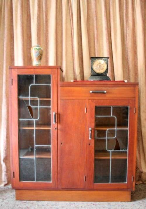 A fantastic solid Teak display cabinet w lead glass doors & large cupboards.