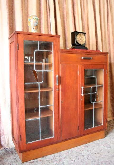 A fantastic solid Teak display cabinet w lead glass doors & large cupboards.
