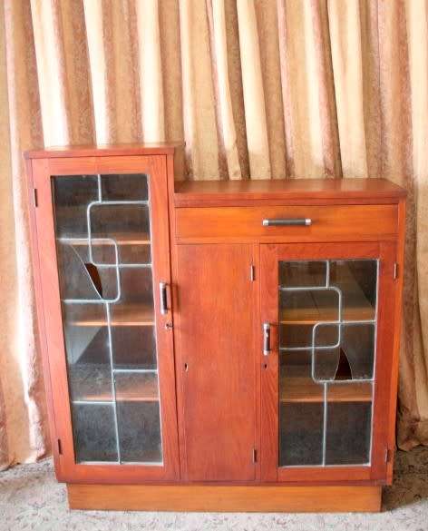 A fantastic solid Teak display cabinet w lead glass doors & large cupboards.