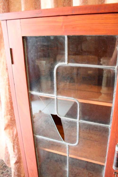 A fantastic solid Teak display cabinet w lead glass doors & large cupboards.