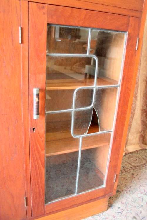 A fantastic solid Teak display cabinet w lead glass doors & large cupboards.