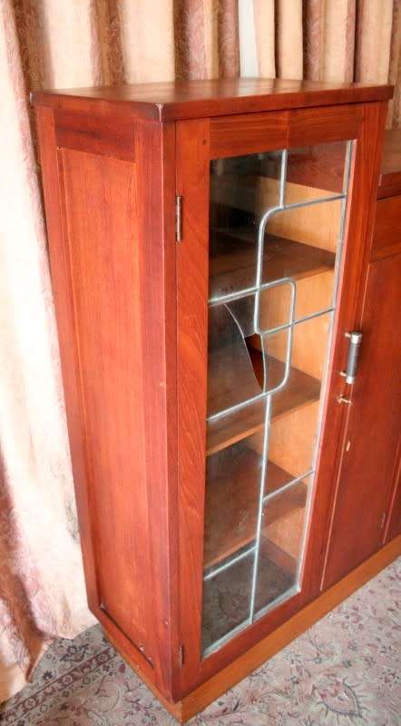 A fantastic solid Teak display cabinet w lead glass doors & large cupboards.