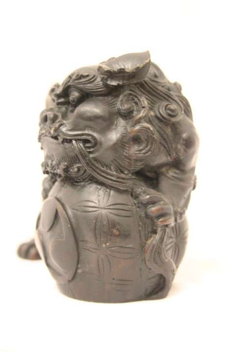 An awesome black oriental resin foo dog/ temple lion ornament