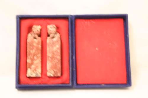 An incredible boxed pair of hand carved red-marble Feng Shui Foo Dog/ Temple Lion ornaments