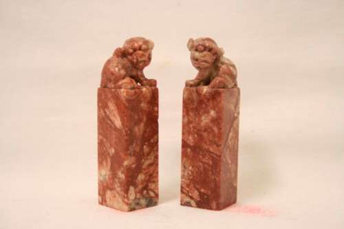 An incredible boxed pair of hand carved red-marble Feng Shui Foo Dog/ Temple Lion ornaments
