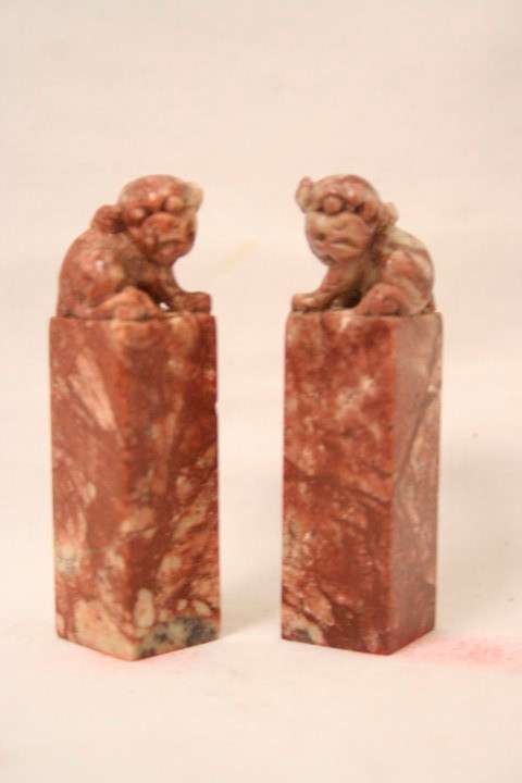 An incredible boxed pair of hand carved red-marble Feng Shui Foo Dog/ Temple Lion ornaments