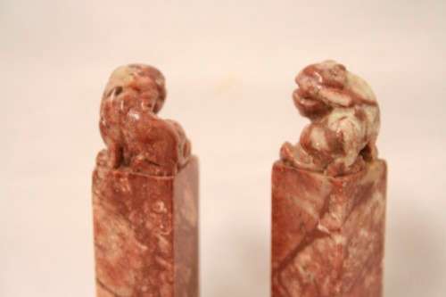 An incredible boxed pair of hand carved red-marble Feng Shui Foo Dog/ Temple Lion ornaments