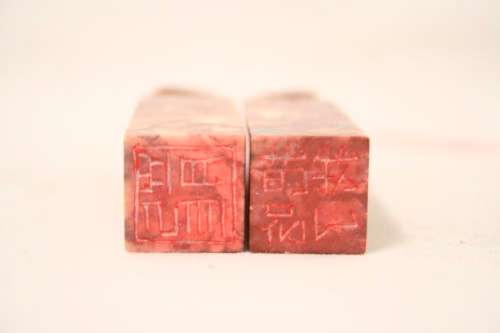 An incredible boxed pair of hand carved red-marble Feng Shui Foo Dog/ Temple Lion ornaments