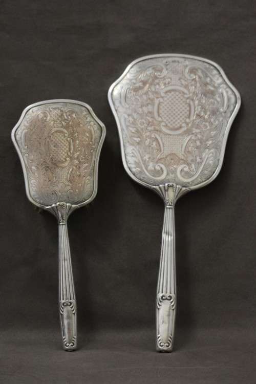 A beautiful antique vanity brush & mirror set w gorgeous pressed detailing.
