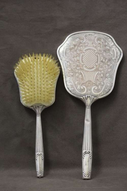 A beautiful antique vanity brush & mirror set w gorgeous pressed detailing.