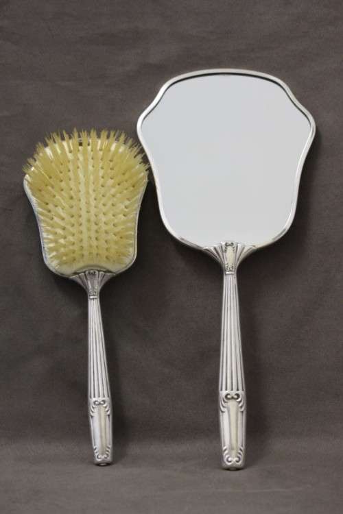 A beautiful antique vanity brush & mirror set w gorgeous pressed detailing.